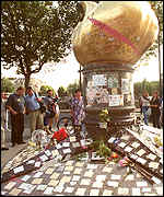 [ image: Tributes have also been left at the makeshift memorial near where she died in Paris]